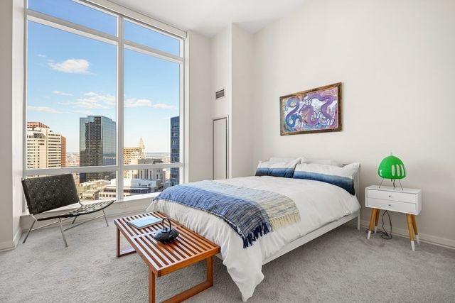 a bedroom with a bed and a couch