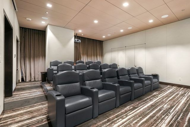 a media room with lots of chairs and a projector