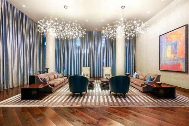 a living room with furniture and a chandelier