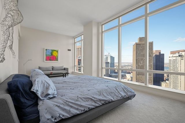 a bedroom with furniture and a large window