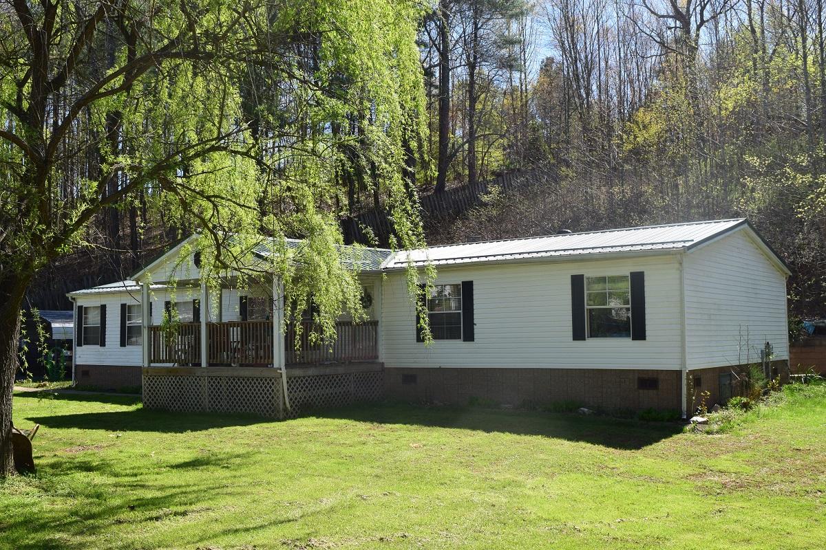 a view of house with yard