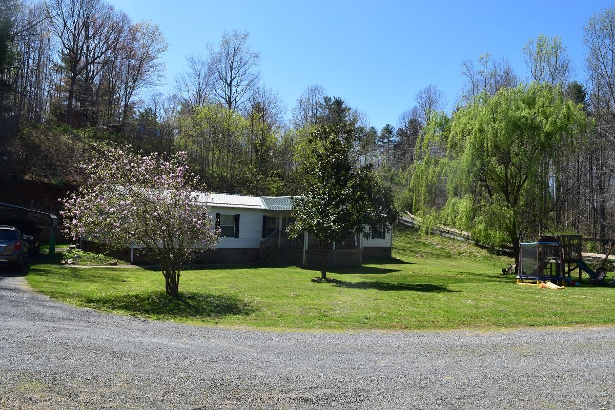 105 Carolina Road Rocky Mount, VA 24151 - Photo 4 of 32 a view of a house with a yard and large trees