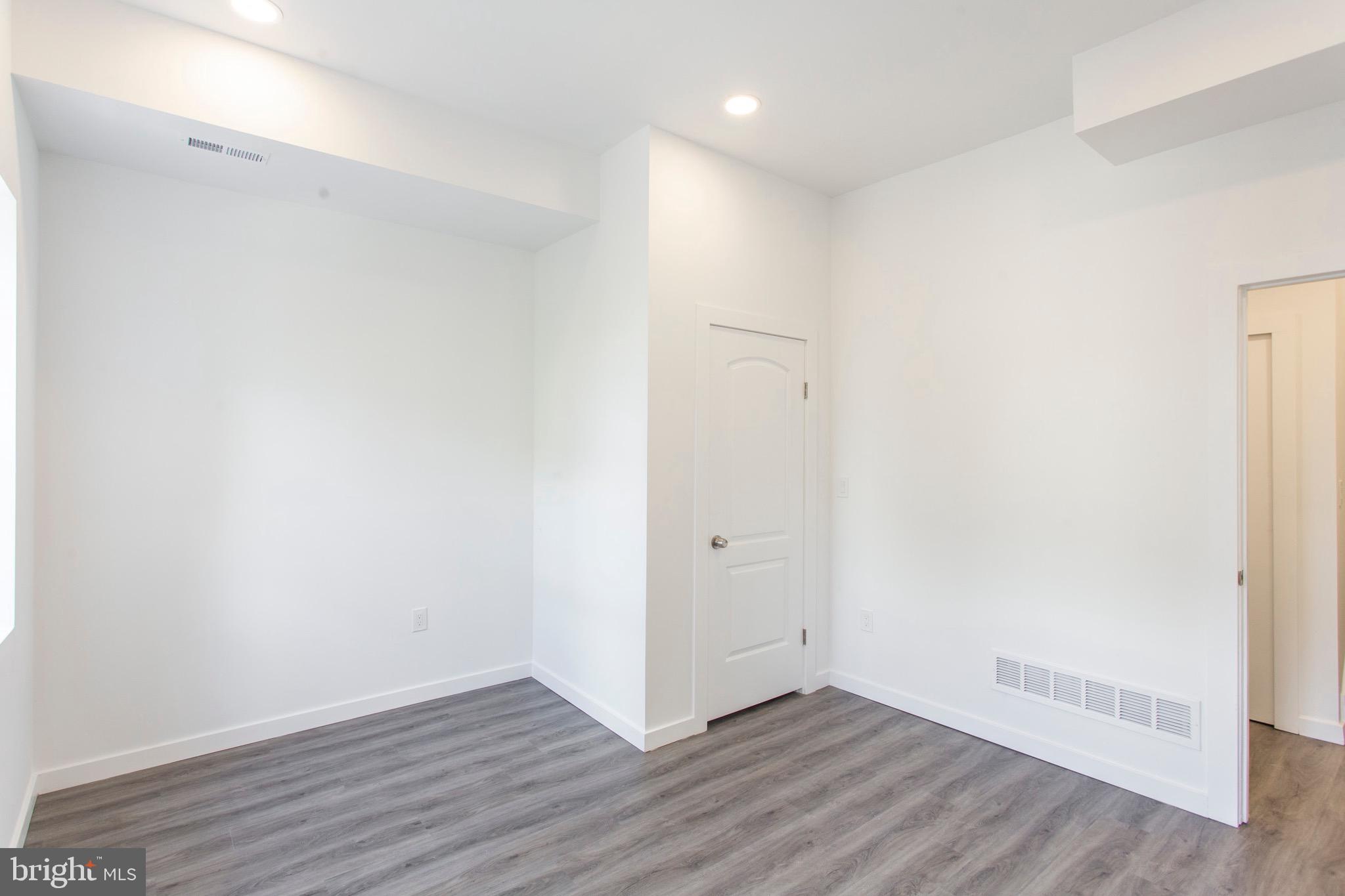 2131 North 8th Street, Unit 2 Philadelphia, PA 19122 - Photo 13 of 19 a view of an empty room with wooden floor