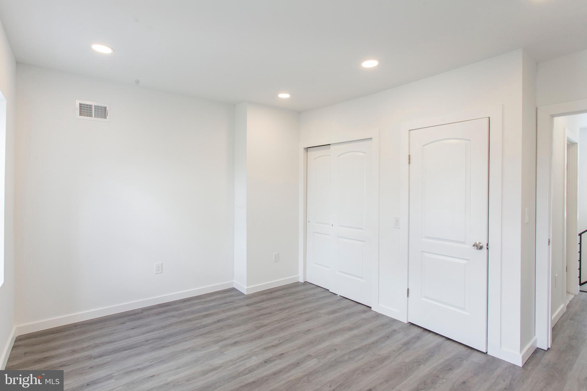 2131 North 8th Street, Unit 2 Philadelphia, PA 19122 - Photo 15 of 19 a view of an empty room with wooden floor