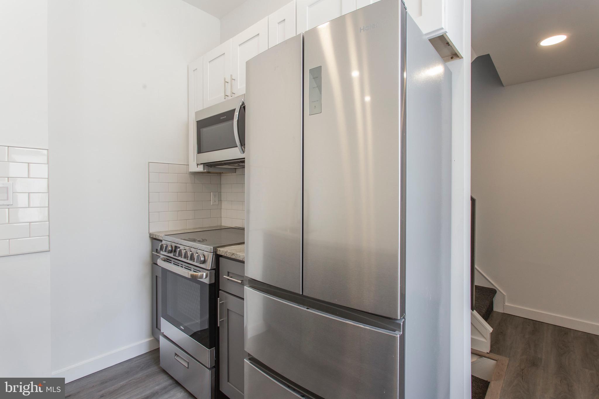 2131 North 8th Street, Unit 2 Philadelphia, PA 19122 - Photo 5 of 19 a kitchen with metallic refrigerator and microwave