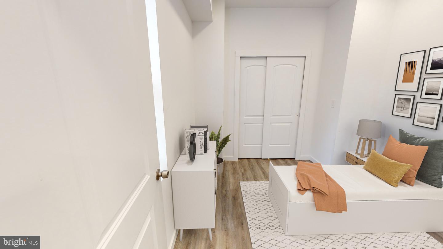 2131 North 8th Street, Unit 2 Philadelphia, PA 19122 - Photo 7 of 19 a bed room with a bed and a couch