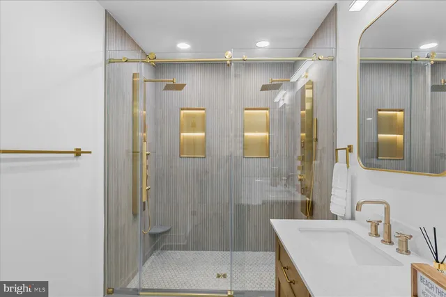a bathroom with a double vanity sink toilet and shower