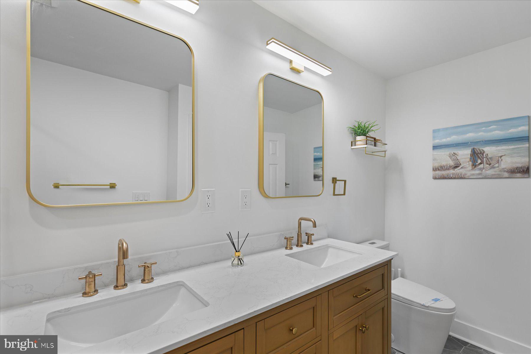 14409 Lighthouse Avenue, Unit 2 Ocean City, MD 21842 - Photo 12 of 39 a bathroom with a toilet sink and mirror