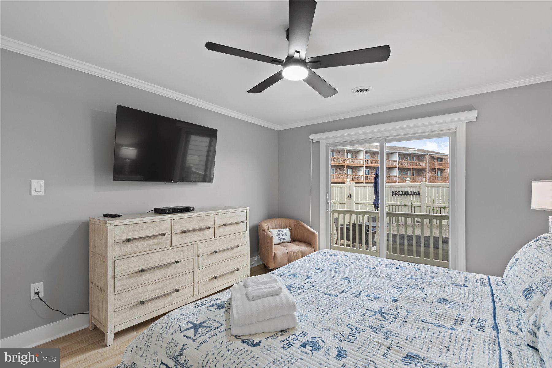 14409 Lighthouse Avenue, Unit 2 Ocean City, MD 21842 - Photo 14 of 39 a bedroom with a bed and a flat screen tv