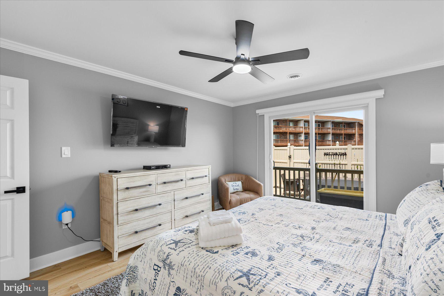 14409 Lighthouse Avenue, Unit 2 Ocean City, MD 21842 - Photo 16 of 39 a bedroom with a bed and a flat screen tv