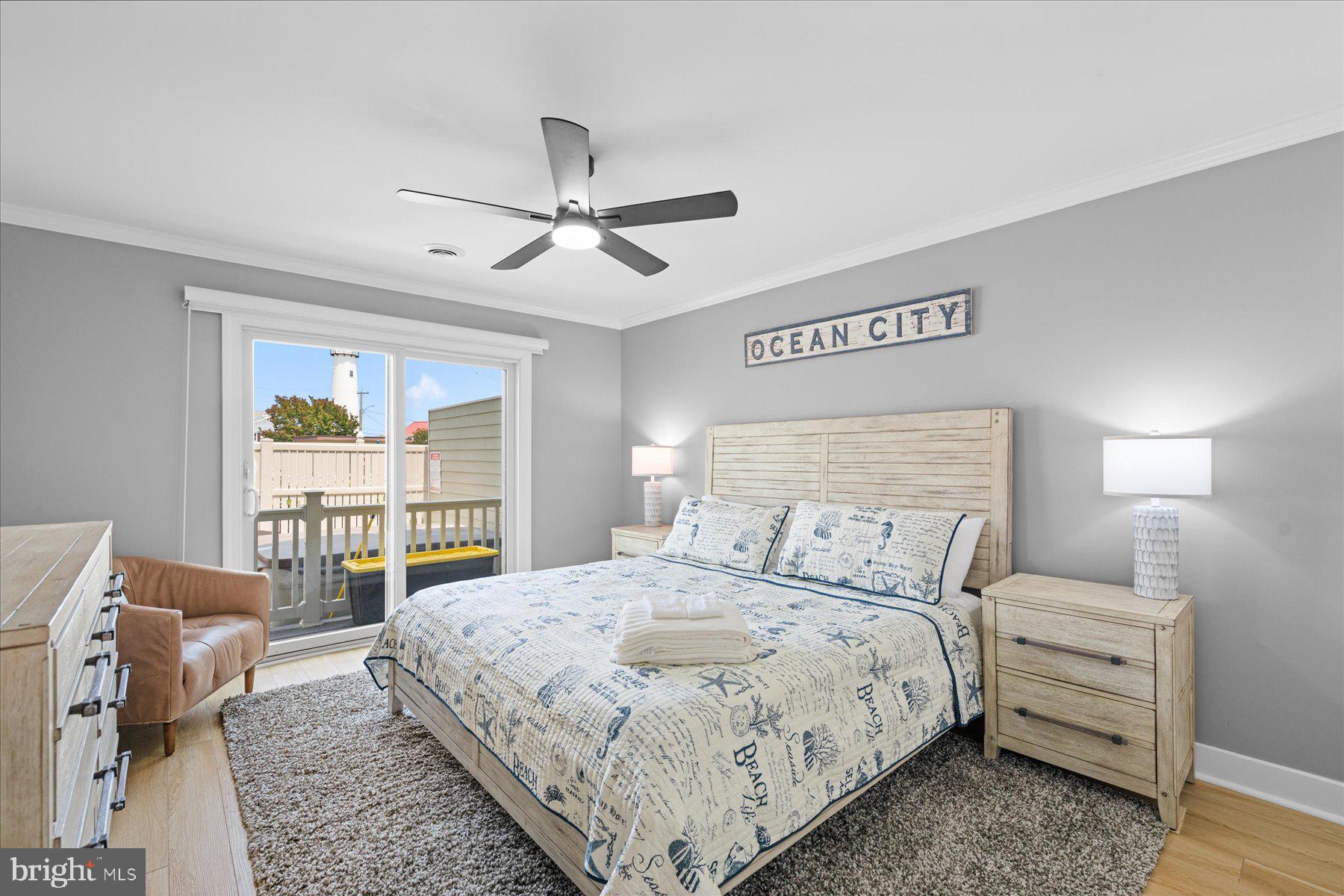 14409 Lighthouse Avenue, Unit 2 Ocean City, MD 21842 - Photo 17 of 39 a bedroom with a large bed and a large window