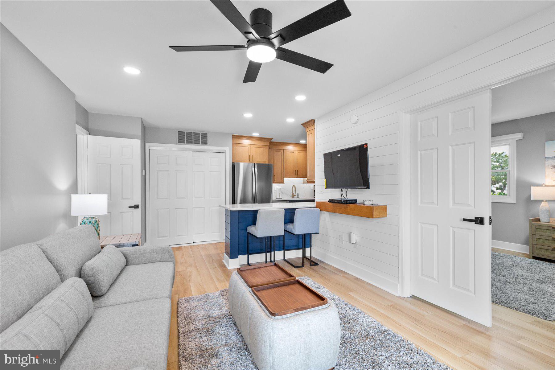 14409 Lighthouse Avenue, Unit 2 Ocean City, MD 21842 - Photo 2 of 39 a living room with furniture and a flat screen tv