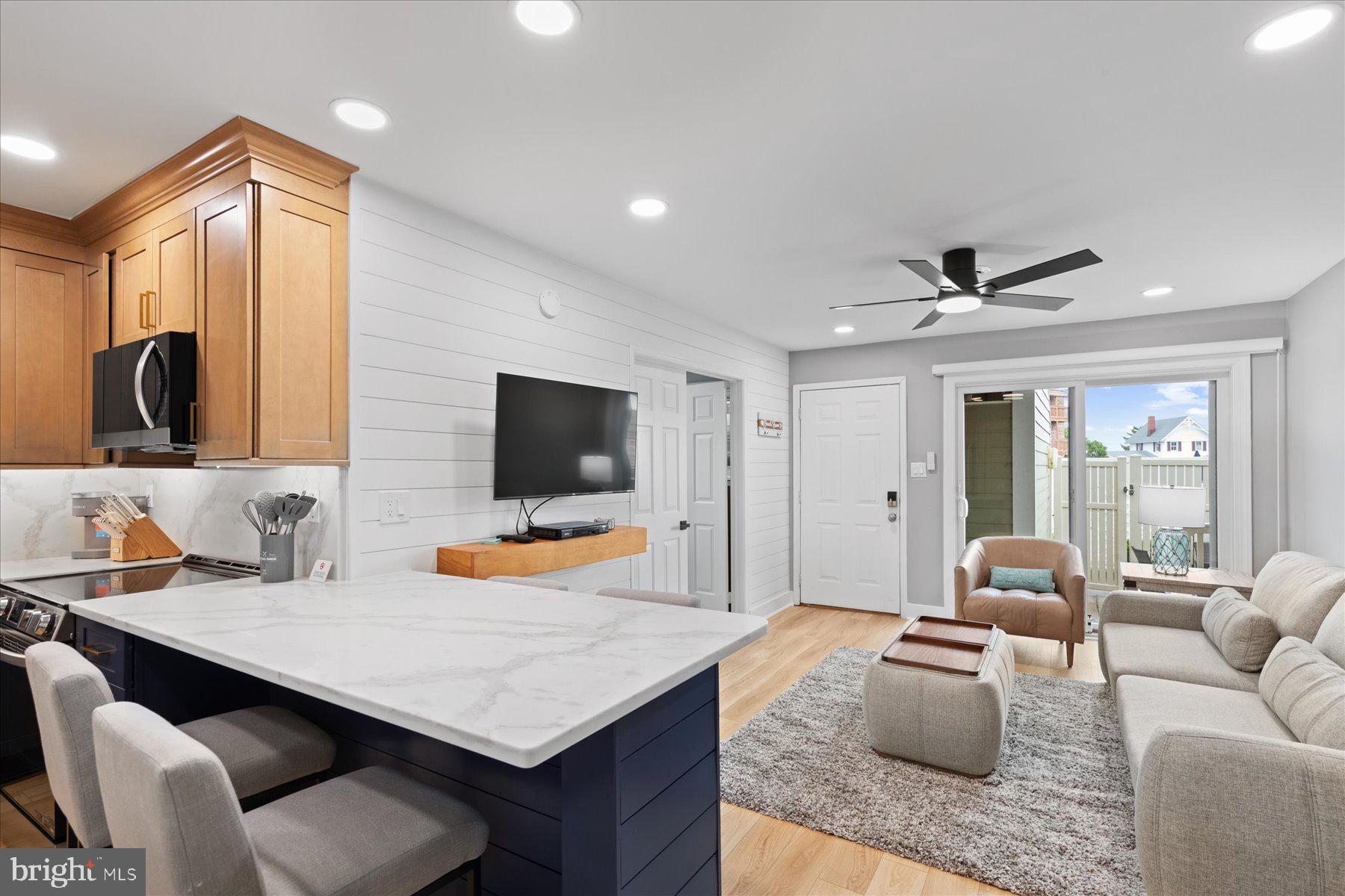 14409 Lighthouse Avenue, Unit 2 Ocean City, MD 21842 - Photo 26 of 39 a living room with furniture kitchen view and a flat screen tv