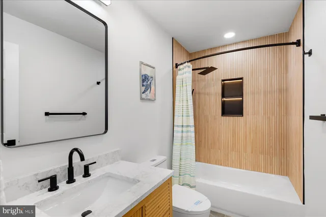 a bathroom with a sink toilet and shower