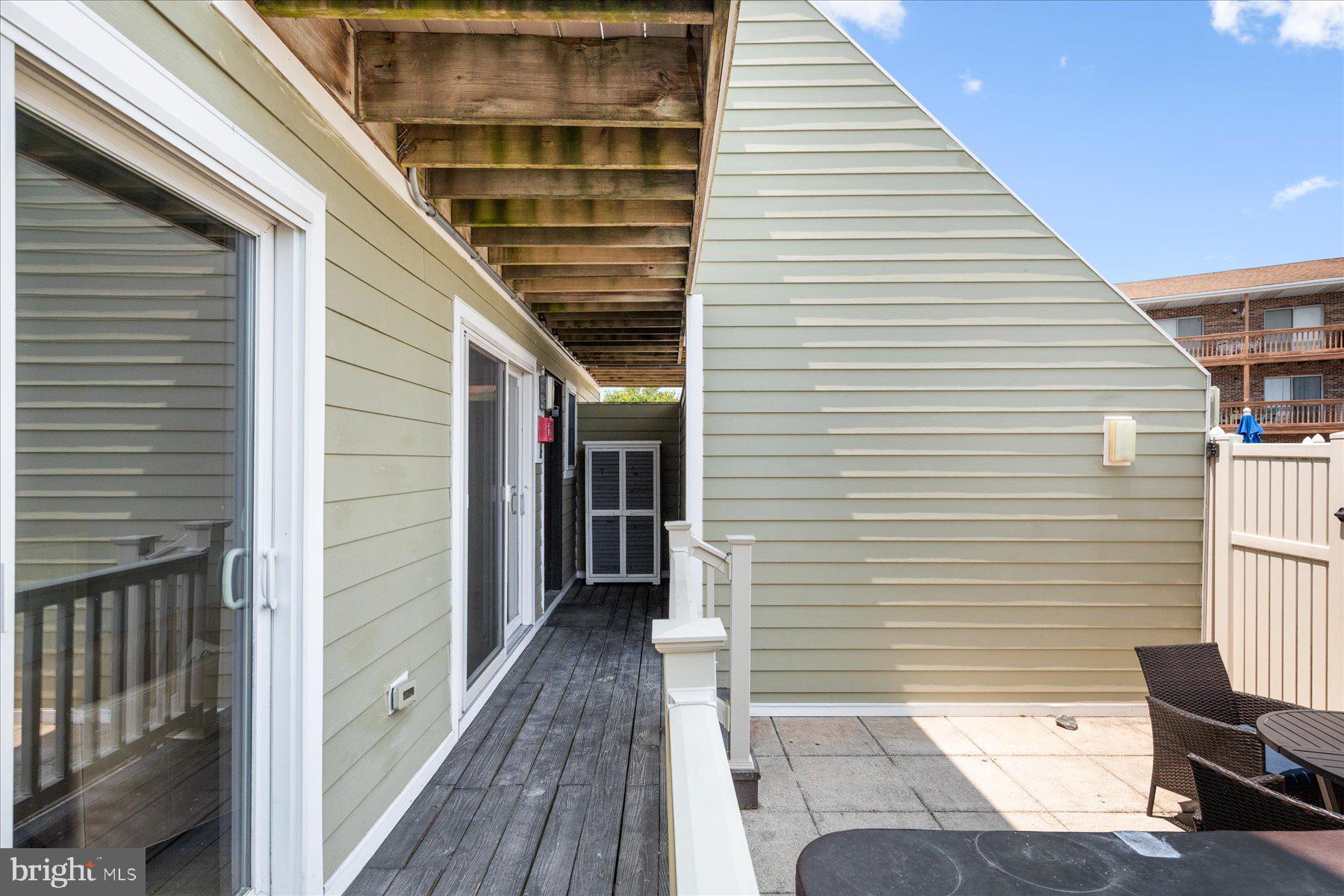 14409 Lighthouse Avenue, Unit 2 Ocean City, MD 21842 - Photo 33 of 39 a view of a balcony with furniture and wooden floor