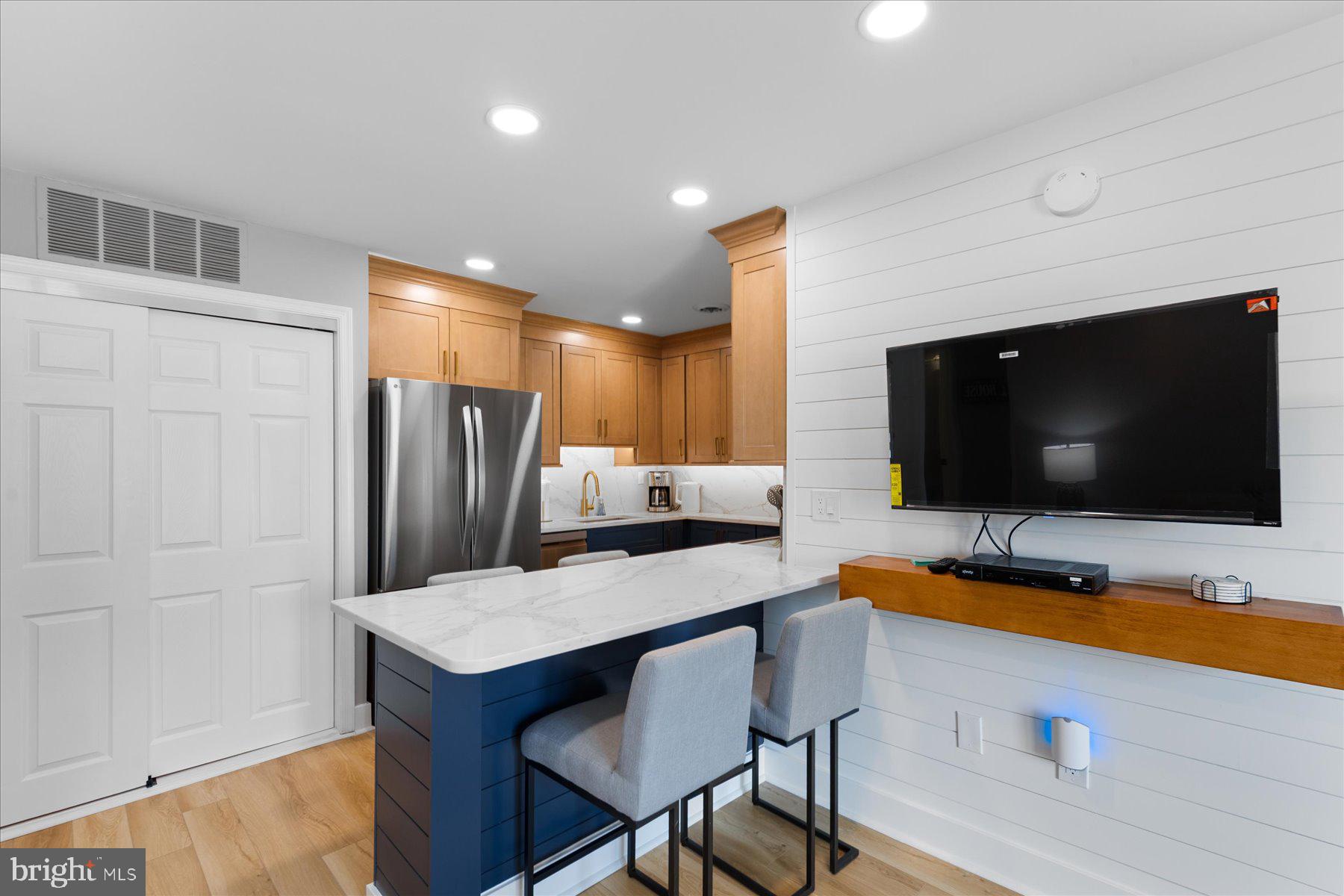 14409 Lighthouse Avenue, Unit 2 Ocean City, MD 21842 - Photo 4 of 39 a room with furniture and a flat screen tv