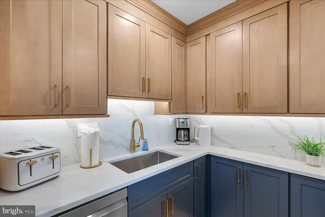 a kitchen with a sink and cabinets