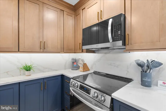 a kitchen with stainless steel appliances a sink a stove and cabinets