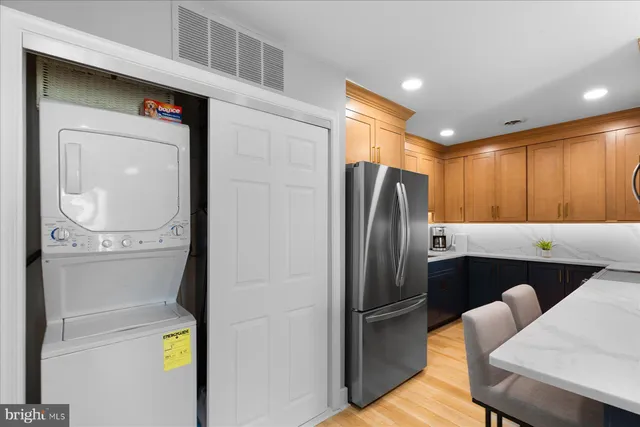 a metallic refrigerator freezer sitting in a kitchen