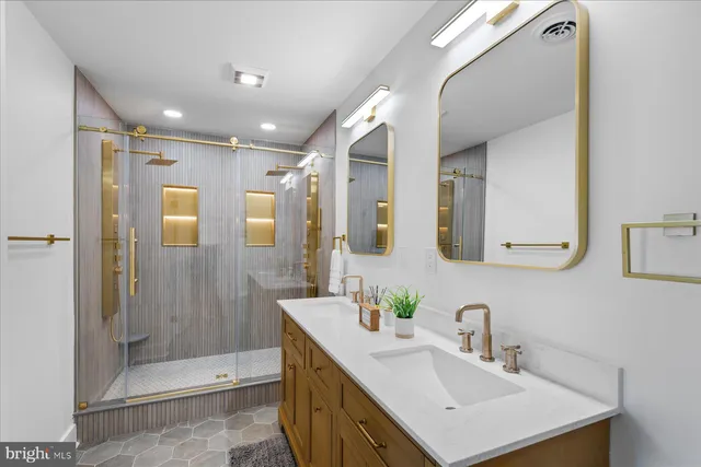 a bathroom with a sink vanity granite shower and a mirror