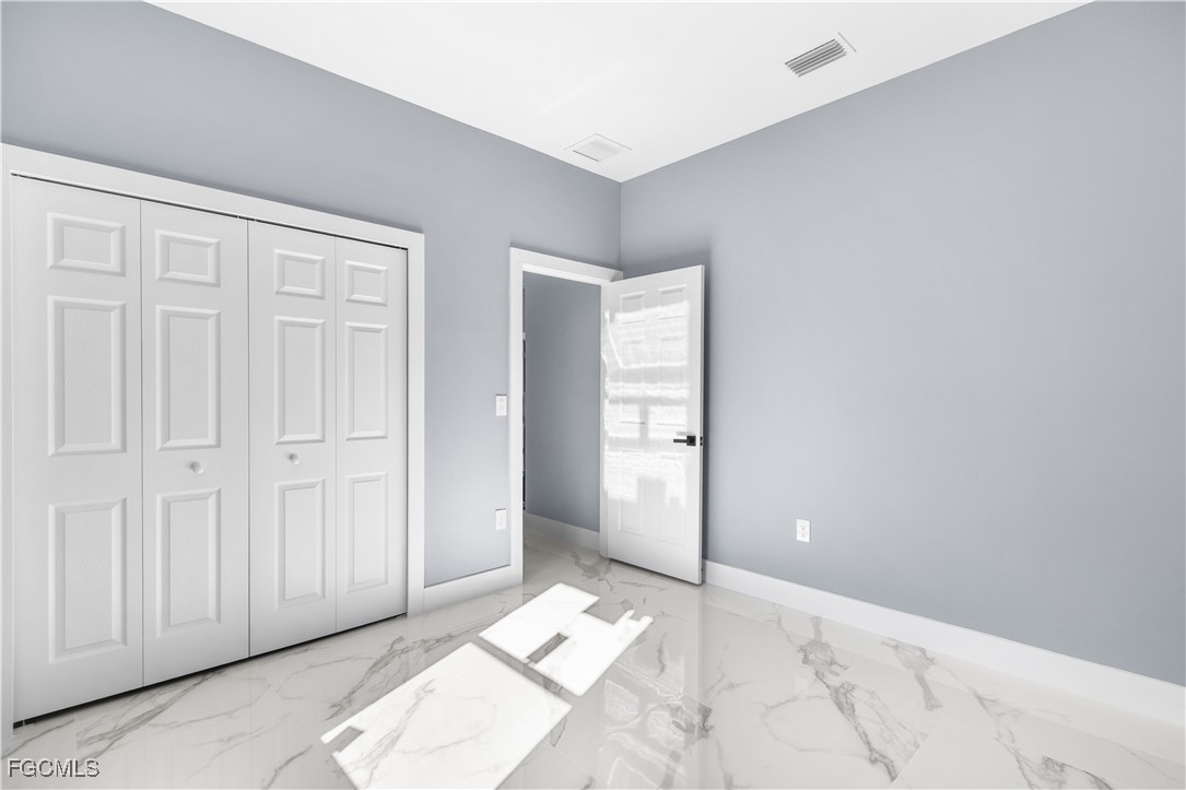 714 Hamilton Avenue Lehigh Acres, FL 33972 - Photo 12 of 30 an empty room with windows