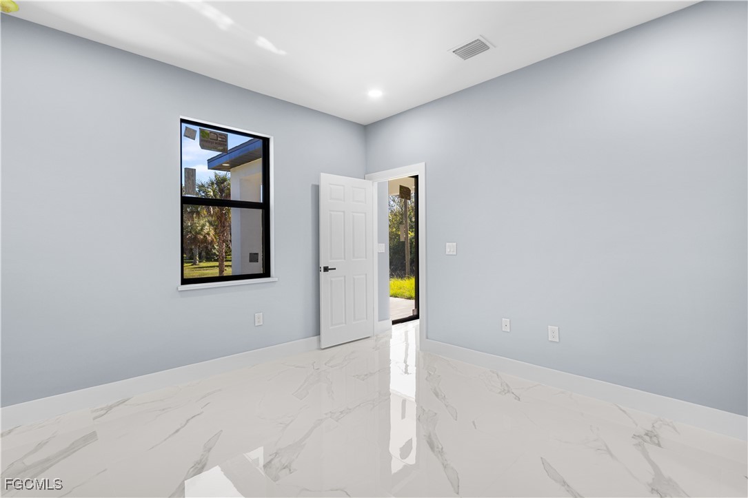 714 Hamilton Avenue Lehigh Acres, FL 33972 - Photo 22 of 30 a view of a hallway with wooden floor