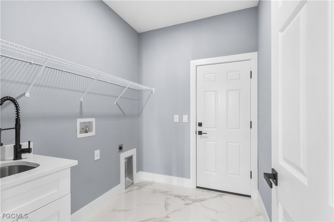 714 Hamilton Avenue Lehigh Acres, FL 33972 - Photo 29 of 30 a bathroom with a sink and mirror