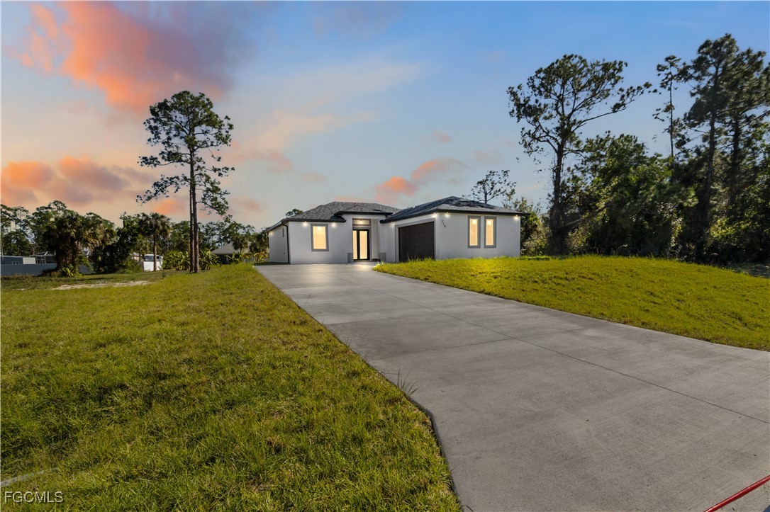 714 Hamilton Avenue Lehigh Acres, FL 33972 - Photo 30 of 30 a view of a house with garden