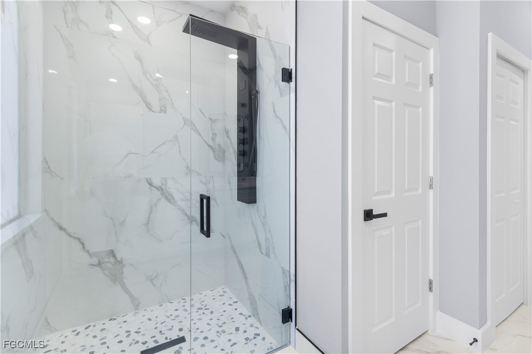 714 Hamilton Avenue Lehigh Acres, FL 33972 - Photo 4 of 30 a bathroom with a shower and a tub