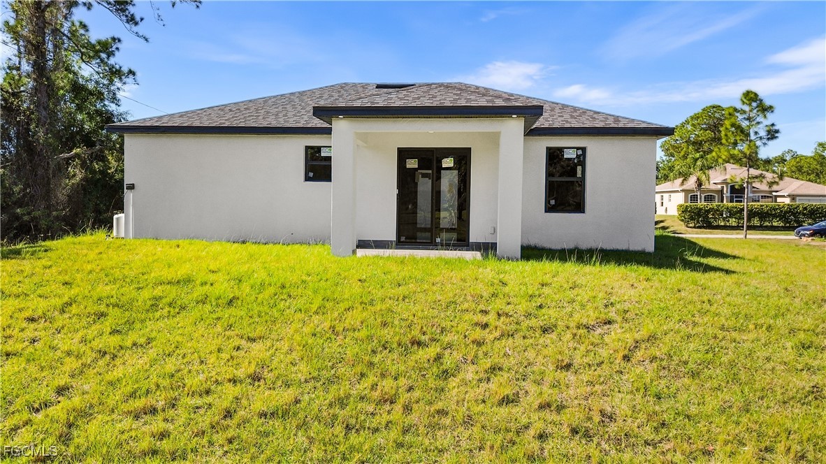 714 Hamilton Avenue Lehigh Acres, FL 33972 - Photo 7 of 30 a house view with swimming pool in front of it