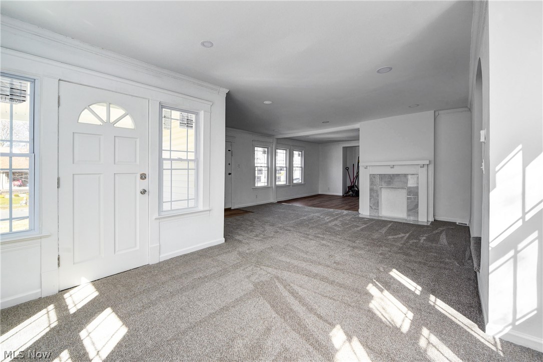 3164 Whitethorn Road Cleveland, OH 44118 - Photo 10 of 31 Entrance foyer featuring a high end fireplace, ornamental molding, dark hardwood / wood-style flooring, and a wealth of natural light