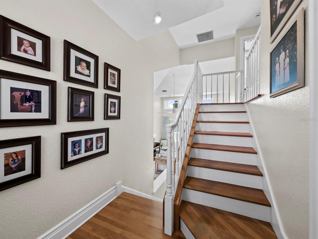 160 Blackwall Court Boca Grande, FL 33921 - Photo 26 of 56 a view of staircase with lots of frames on wall