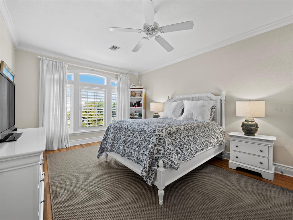 160 Blackwall Court Boca Grande, FL 33921 - Photo 28 of 56 a bedroom with a bed and a flat tv screen on dresser