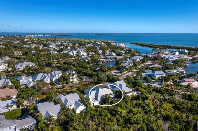a living room with furniture and floor to ceiling windows