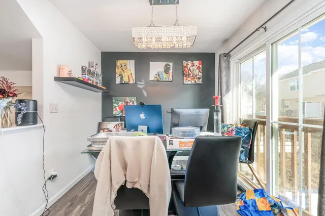 a view of a dining room with furniture and a window