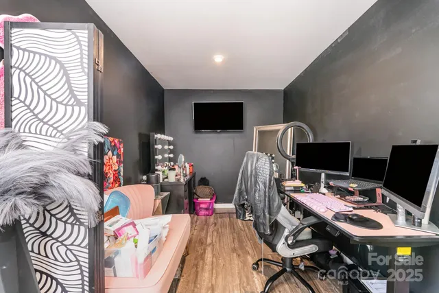 a view of a workspace with furniture and a flat screen tv