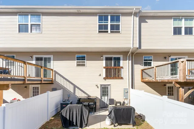 a view of a house with a wooden deck