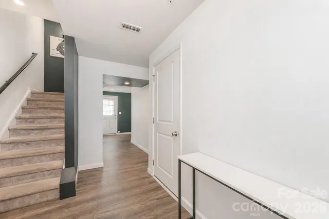 a kitchen with kitchen island a counter top space a sink stainless steel appliances and cabinets