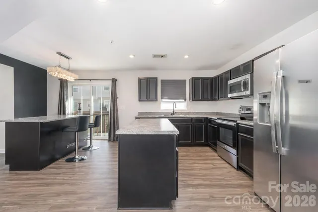 a bedroom with bed a flat tv screen and a large window with the garden view