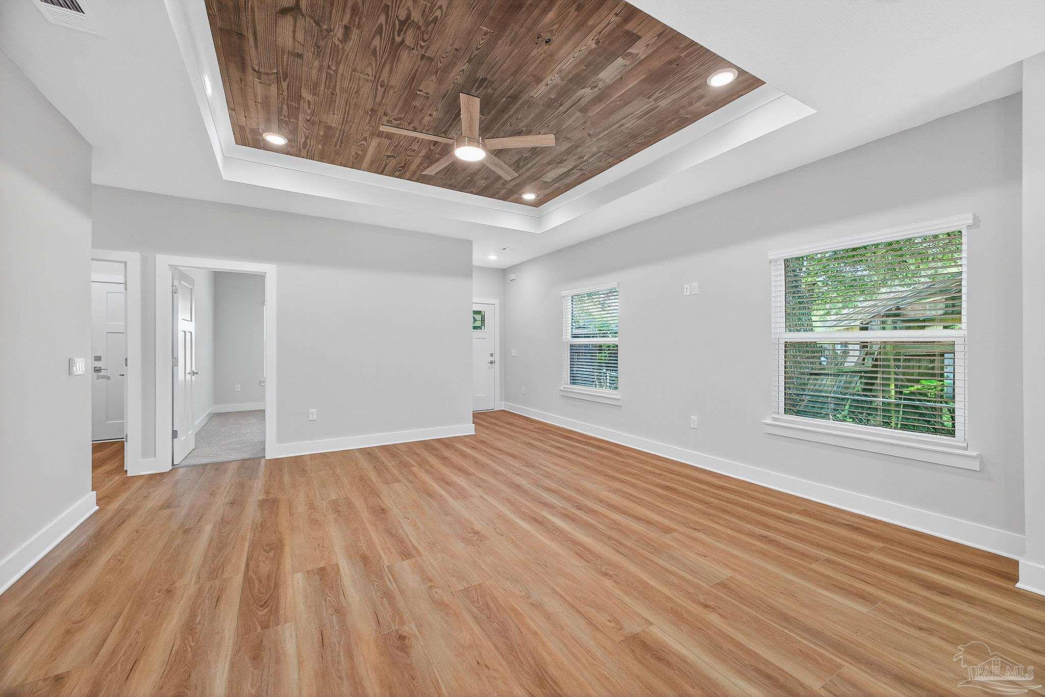 6115 Carroll Road Milton, FL 32583 - Photo 11 of 57 a view of an empty room with wooden floor and a window