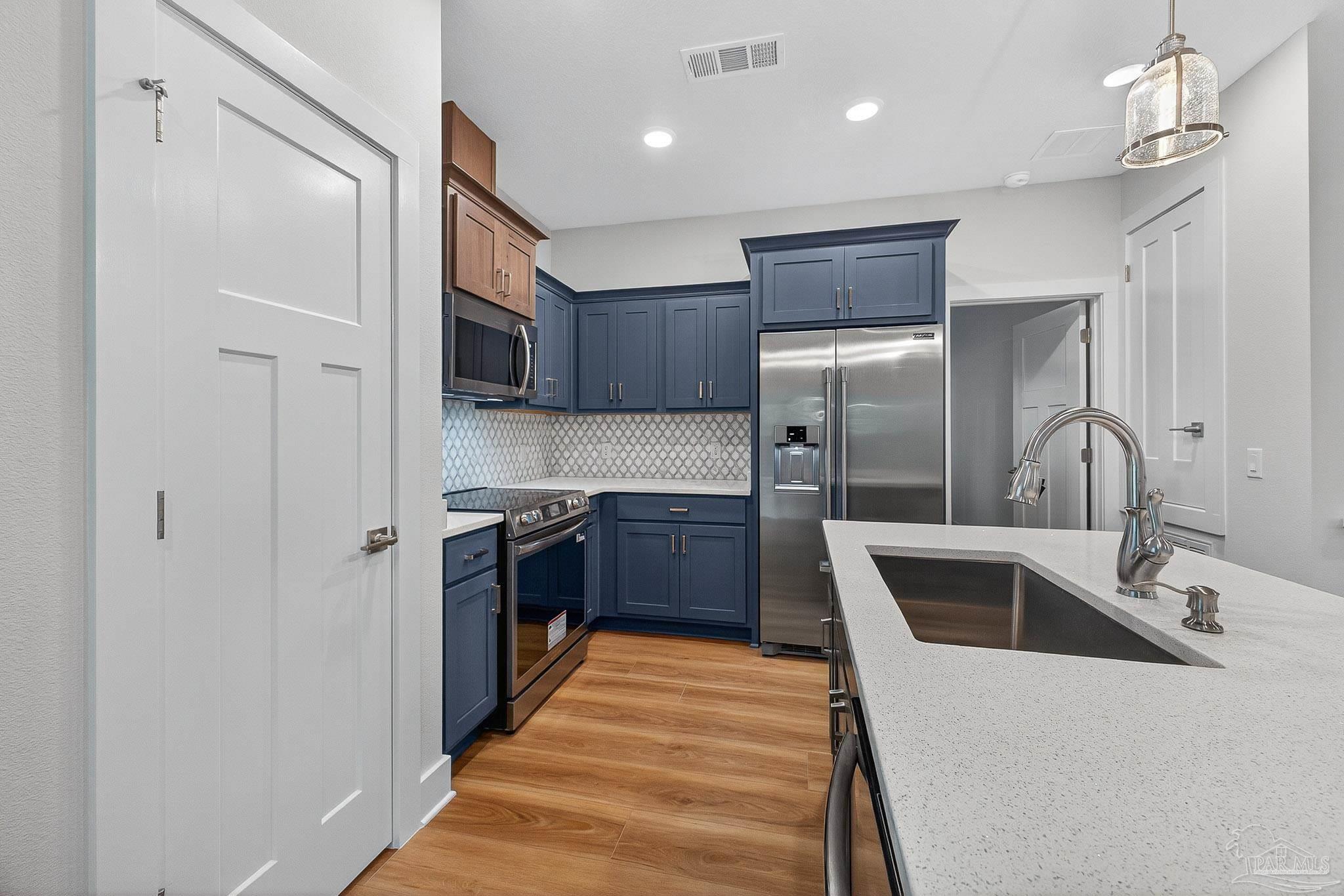 6115 Carroll Road Milton, FL 32583 - Photo 21 of 57 a kitchen with stainless steel appliances granite countertop a sink and a refrigerator