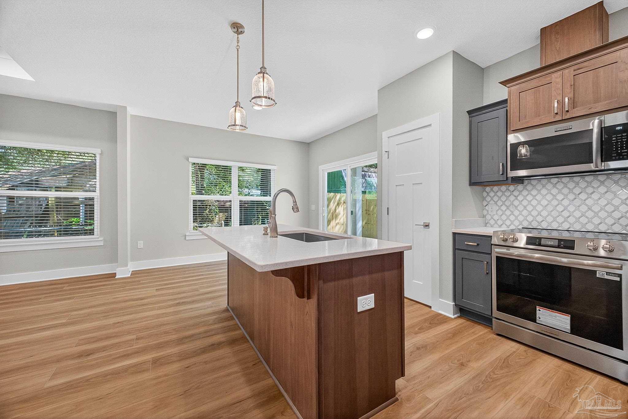 6115 Carroll Road Milton, FL 32583 - Photo 25 of 57 a kitchen with stainless steel appliances granite countertop a stove and a microwave
