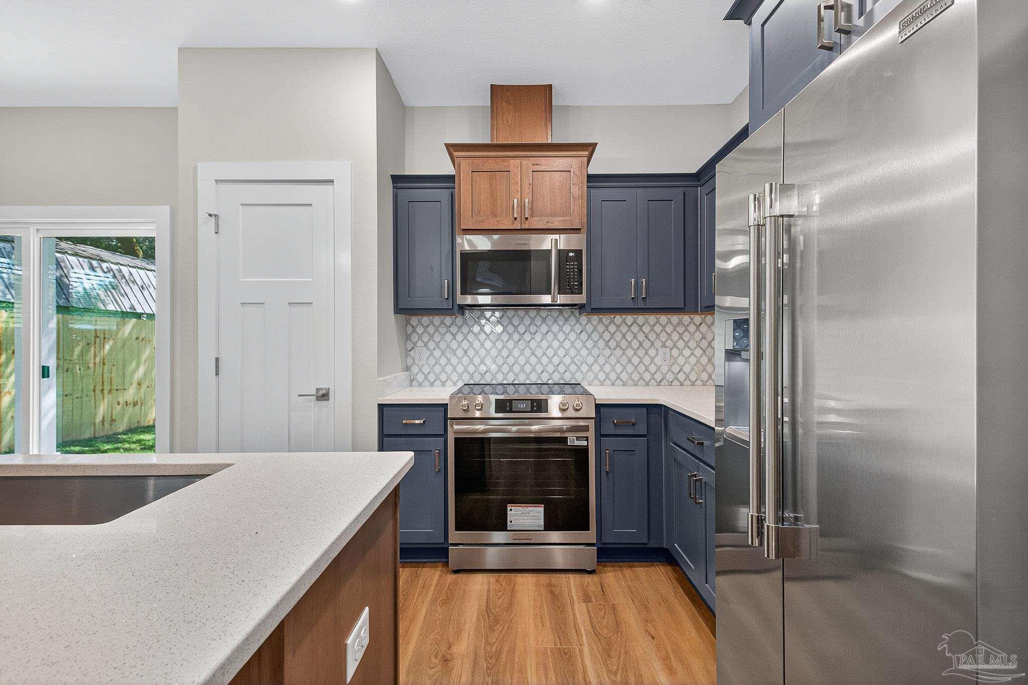 6115 Carroll Road Milton, FL 32583 - Photo 26 of 57 a kitchen with a stove and a refrigerator