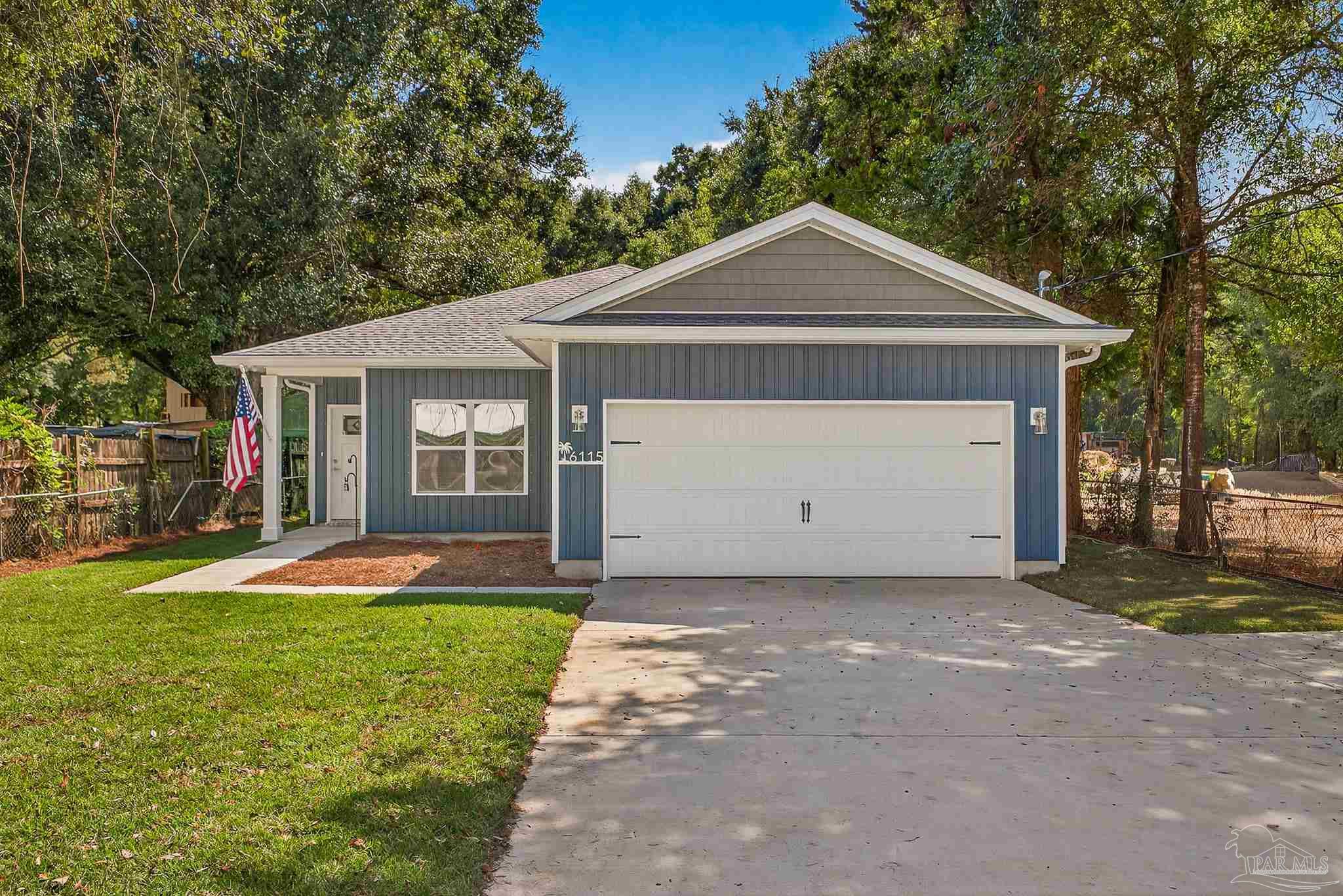 6115 Carroll Road Milton, FL 32583 - Photo 5 of 57 a front view of a house with yard and garage