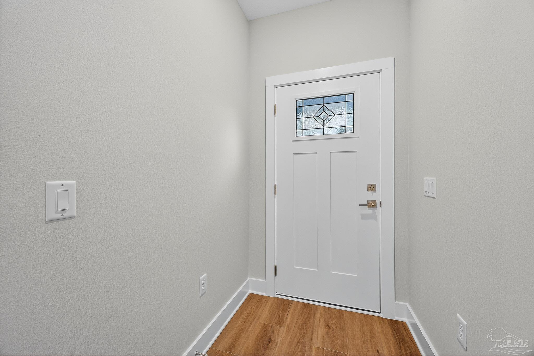 6115 Carroll Road Milton, FL 32583 - Photo 7 of 57 a view of room with window and wooden floor