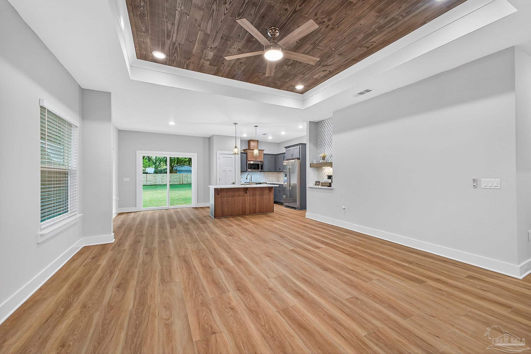 6115 Carroll Road Milton, FL 32583 - Photo 8 of 57 a view of empty room with wooden floor and window