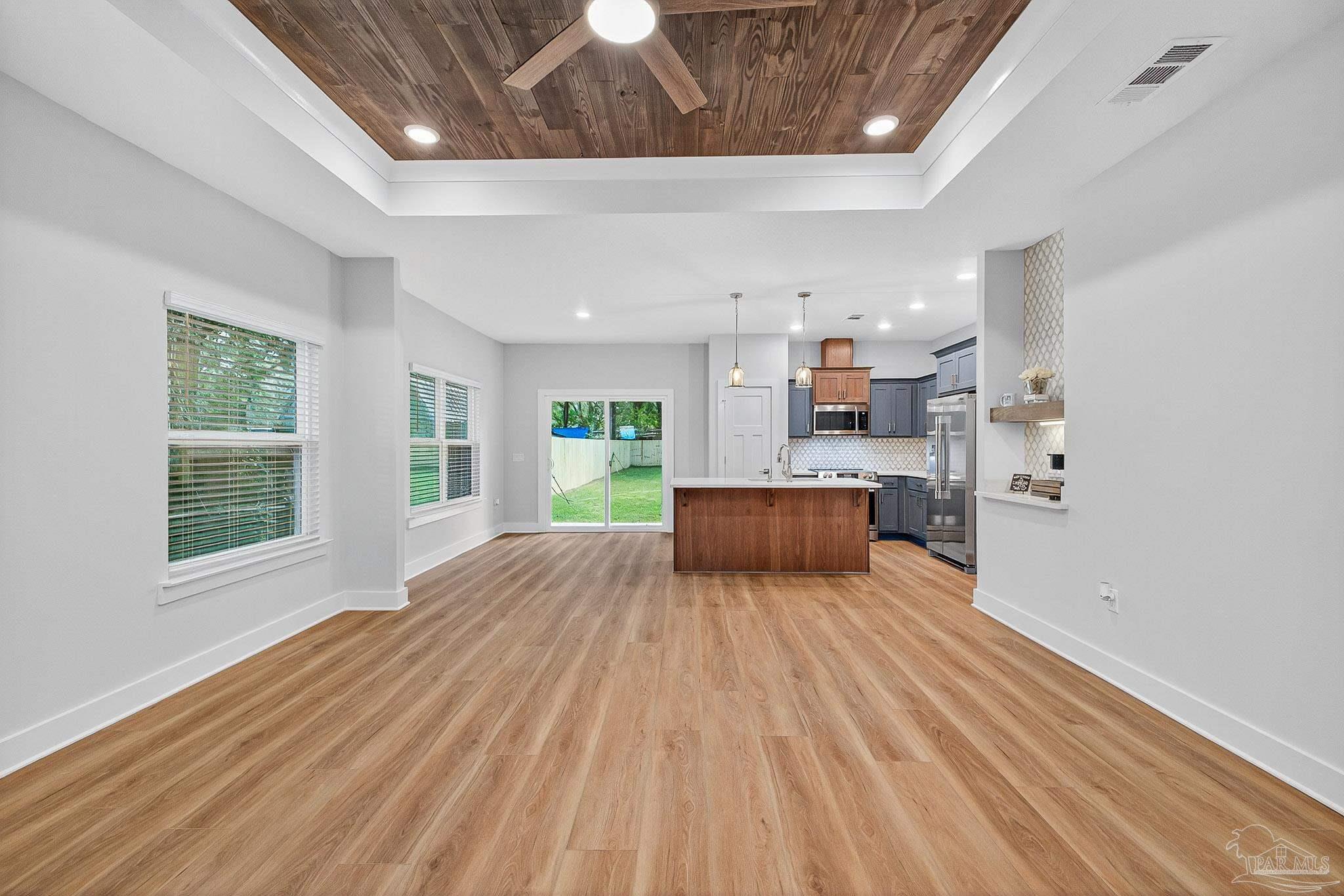 6115 Carroll Road Milton, FL 32583 - Photo 9 of 57 a large room with kitchen island