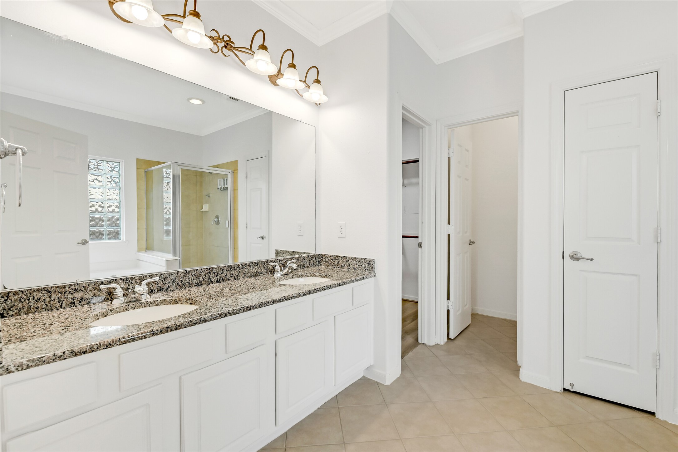 19227 Countryhills Court Spring, TX 77388 - Photo 22 of 33 Elegant dual vanities enhance the primary bathroom's functionality and style.