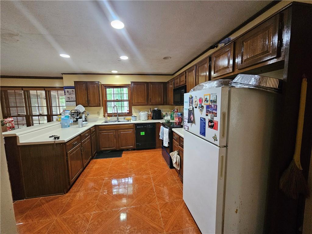 1935 Coventry Way Jonesboro, GA 30236 - Photo 16 of 33 a kitchen with stainless steel appliances granite countertop a refrigerator a sink dishwasher a stove and a dining table with wooden floor