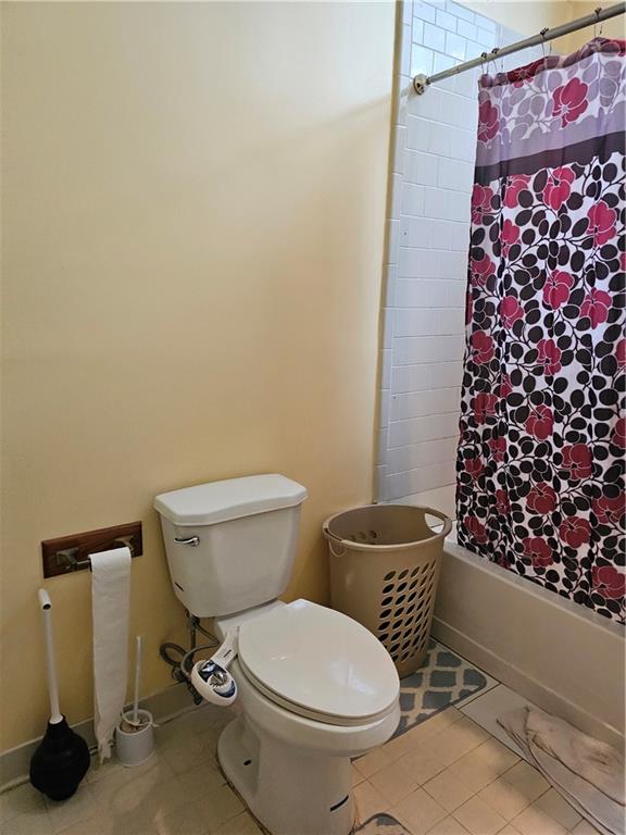 1935 Coventry Way Jonesboro, GA 30236 - Photo 24 of 33 a white toilet sitting next to a shower curtain